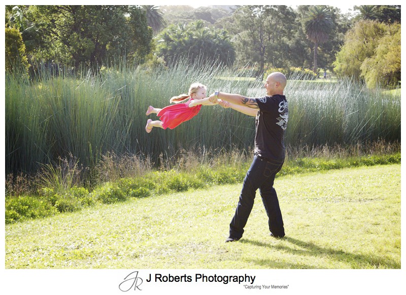 father and daughter in air swing in centennial park - family portrait photography - sydney
