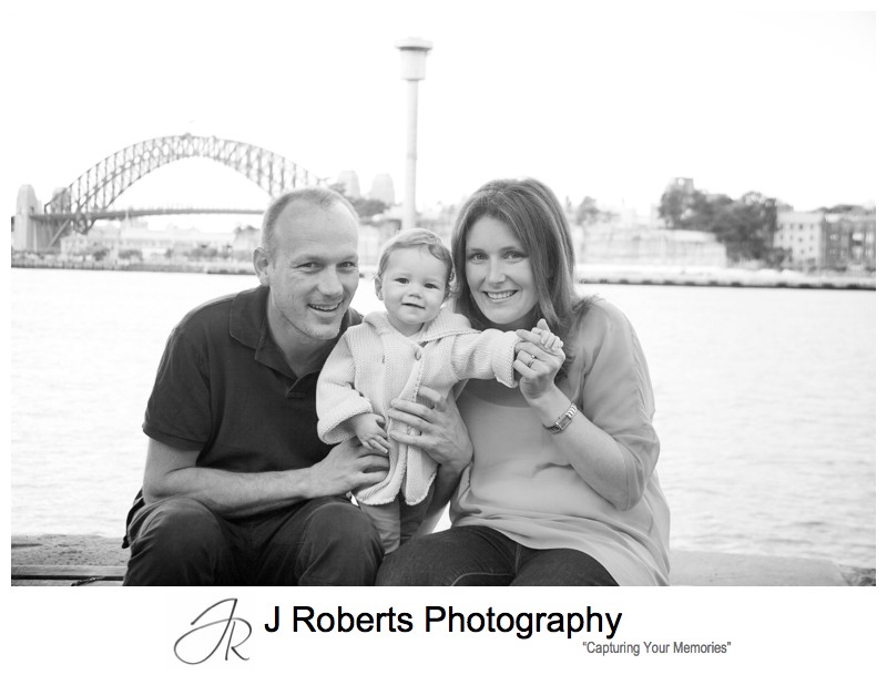 B&W portrait of family with Sydney Harbour Bridge - family portrait photography sydney