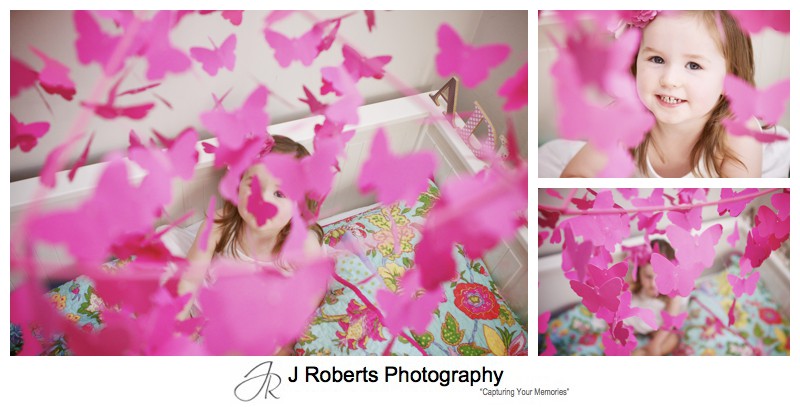 Little girl with pink butterfly mobile - family portrait photography sydney