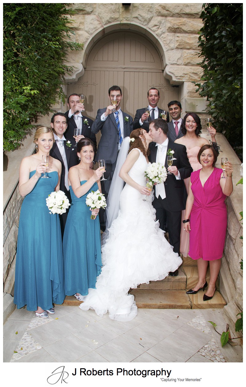 Extended bridal party celebrate with champagne - wedding photography sydney