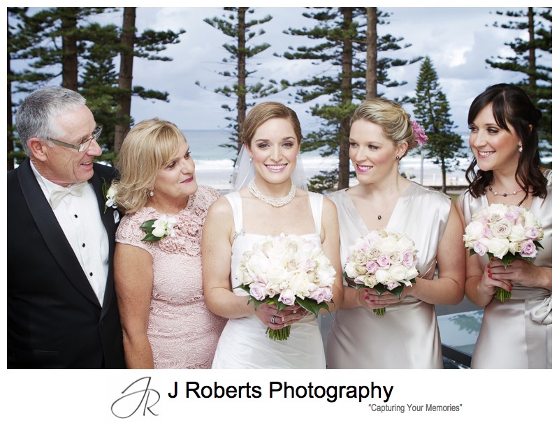 Bride with her family and Manly beach as backdrop - wedding photography sydney