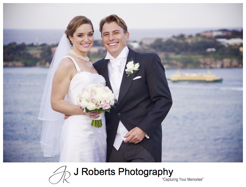 Bride and groom with Sydney Harbour and the Manly Ferry - wedding photography sydney