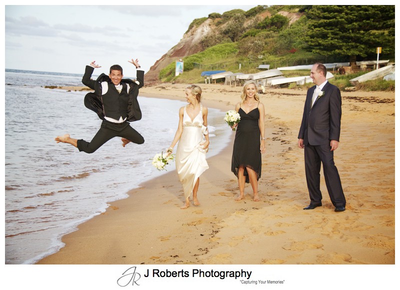 Groom jumping with bridal party laughing - wedding photography sydney