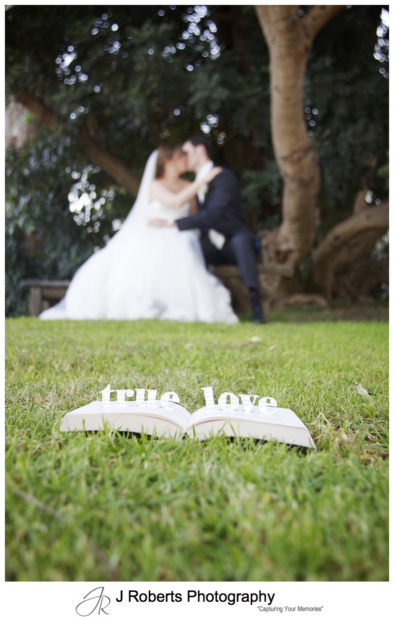Bride and groom with 'true love' carved in a book - wedding photography sydney