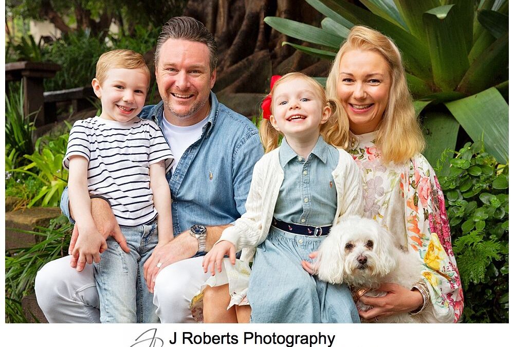 Family portrait fun in the rain in Sydney gumboots and umbrellas Wendy Whiteleys Garden Lavender Bay